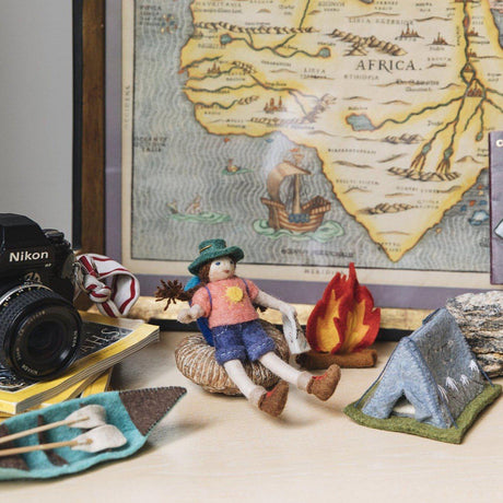 A Craftspring handmade felt Backpacker ornament with long braided pigtails a backpacker backpack and holding a map